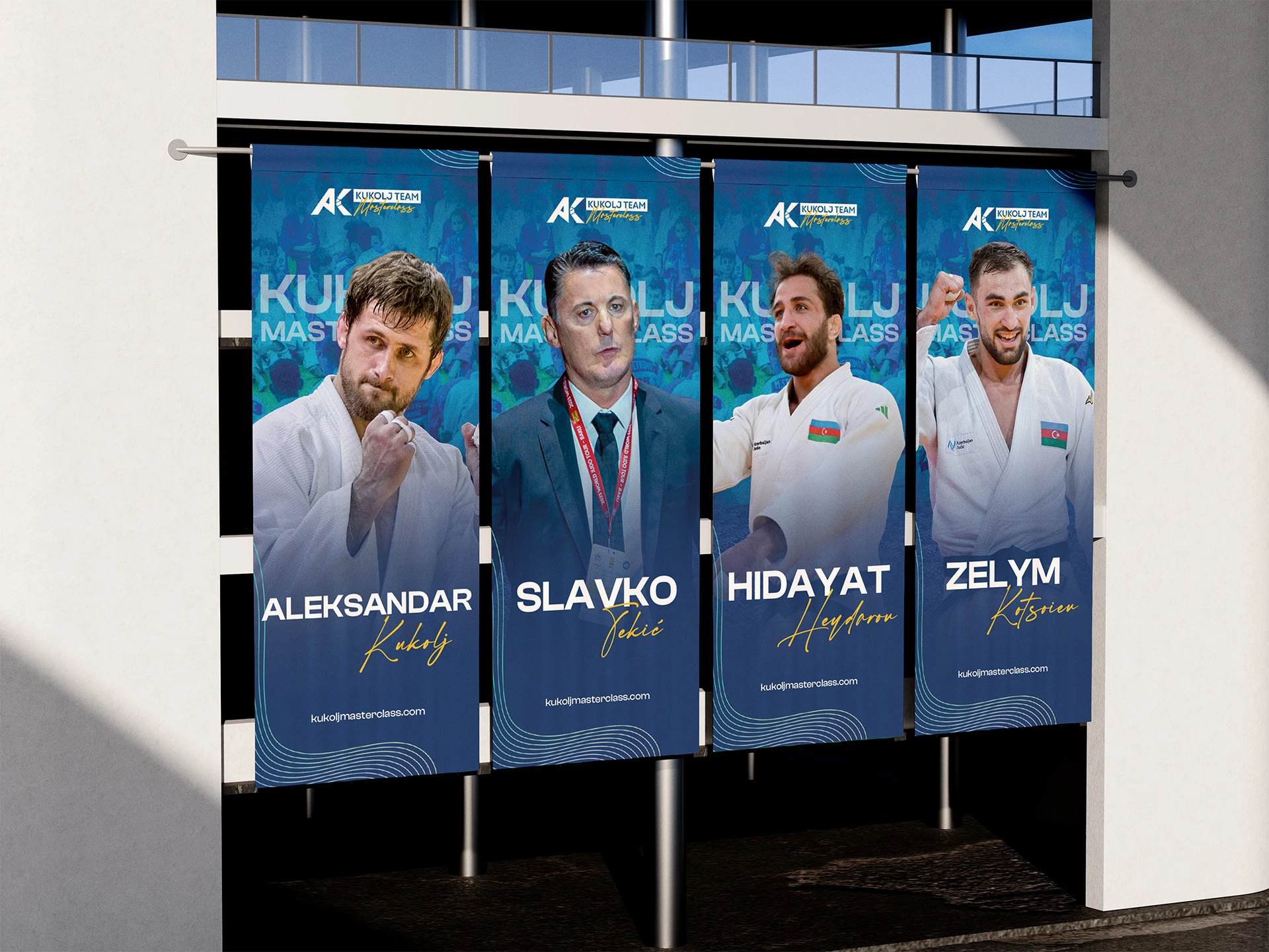 Četiri vertikalna banera iz 2025. na zgradi, po jedan za svakog trenera: Aleksandar Kukolj, Slavko Tekić, Hidayat Heydarov i Zelym Kotsoiev